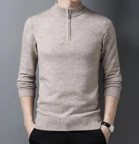 A sleek slim-fit sweater with a quarter-zip collar, worn by a male model against a neutral gray background. The sweater features ribbed cuffs and a ribbed hem for a snug and polished fit. The model pairs it with light-colored trousers and a silver wristwatch, creating a refined and sophisticated look.