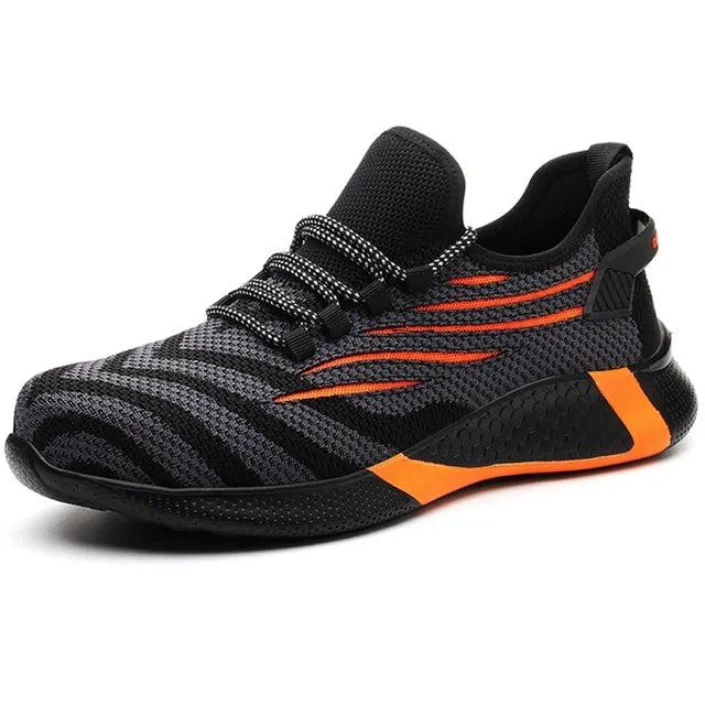 A black and dark gray athletic sneaker with a breathable knit upper, accented by bold orange wave-like stripes on the sides and orange detailing on the midsole. The shoe features a thick, textured sole and black-and-white patterned laces, designed for both style and performance.