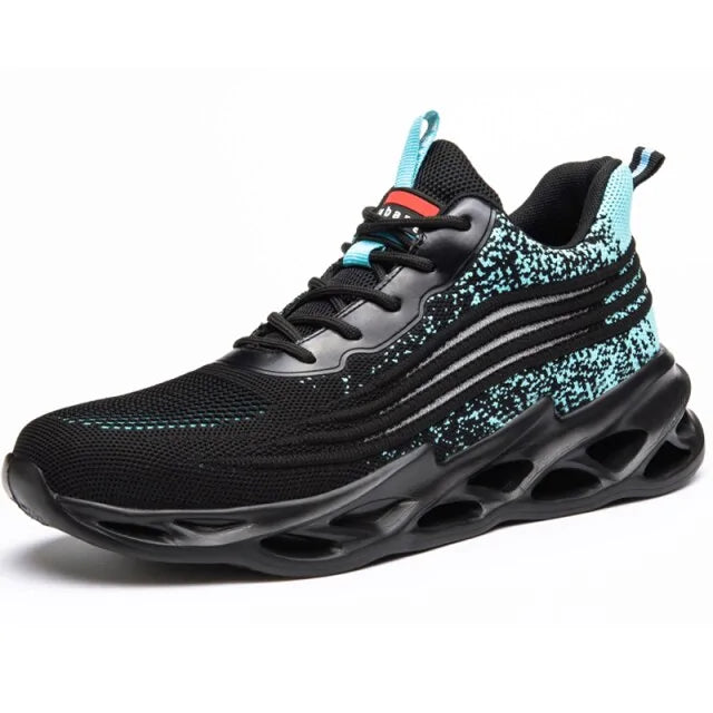 A black and dark gray athletic sneaker with a breathable knit upper, accented by bold orange wave-like stripes on the sides and orange detailing on the midsole. The shoe features a thick, textured sole and black-and-white patterned laces, designed for both style and performance.