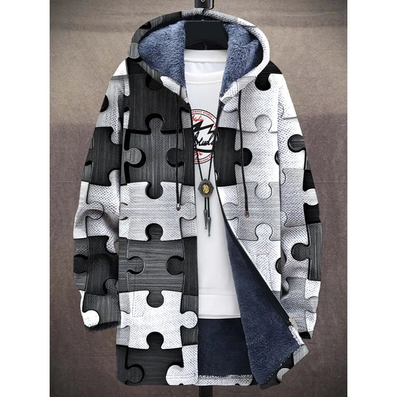 A stylish fleece-lined hoodie featuring a bold black-and-white puzzle piece design. The contrasting monochrome puzzle pattern creates a striking visual effect. The hoodie is lined with plush deep blue fabric for warmth and comfort. It includes black drawstrings and is styled with a white inner shirt and a pendant necklace for a trendy, layered look.