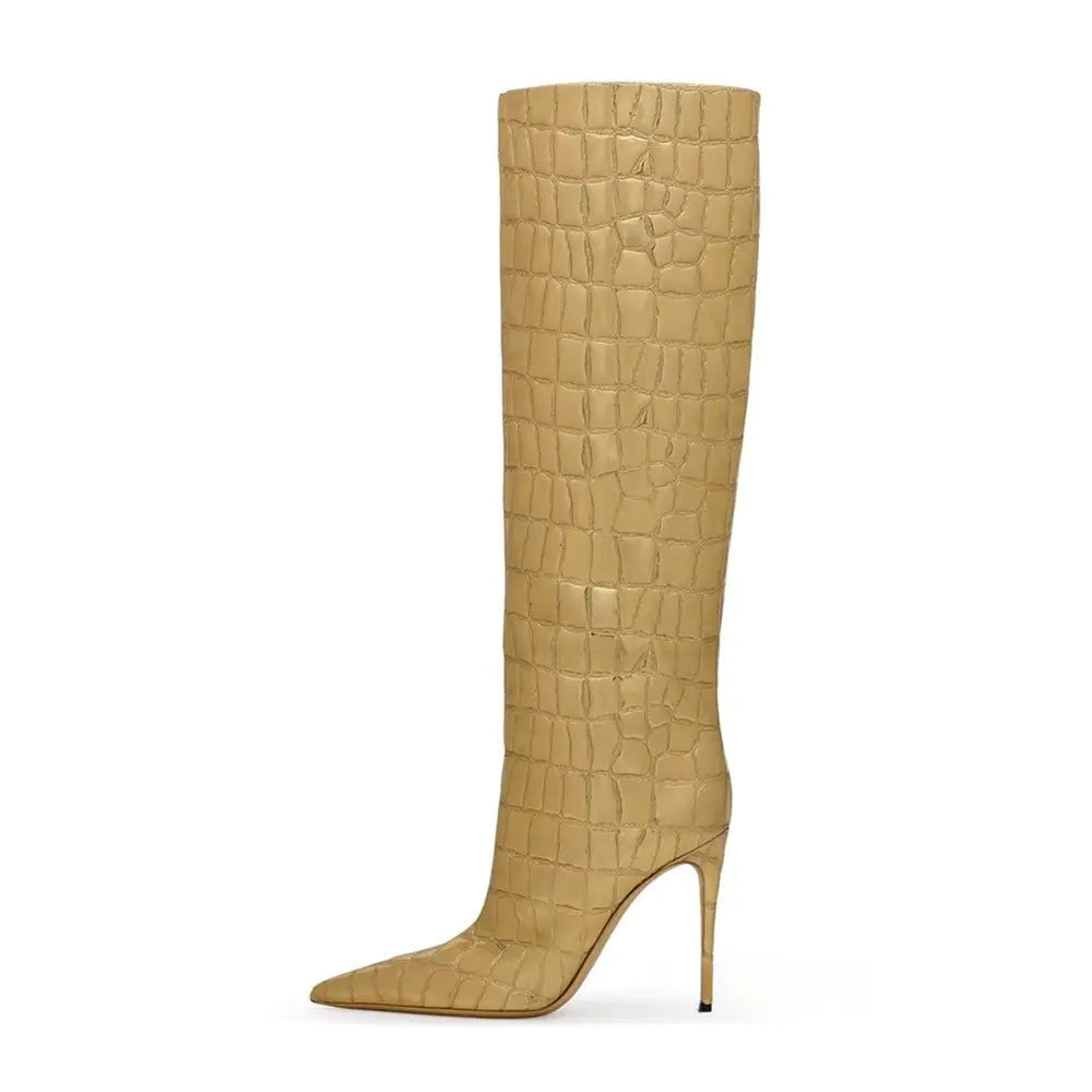A single high-fashion women's knee-high boot in beige with a faux crocodile skin texture. The boot features a pointed toe and a slender stiletto heel, exuding a luxurious and stylish appearance. It is photographed against a plain white background, showcasing its elegant structure and upscale finish.