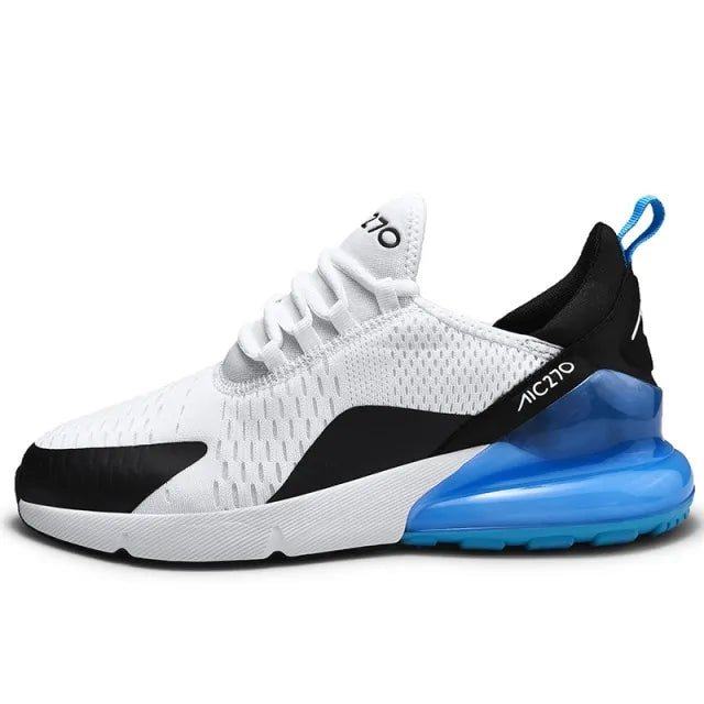 A black and dark gray athletic sneaker with a breathable knit upper, accented by bold orange wave-like stripes on the sides and orange detailing on the midsole. The shoe features a thick, textured sole and black-and-white patterned laces, designed for both style and performance.