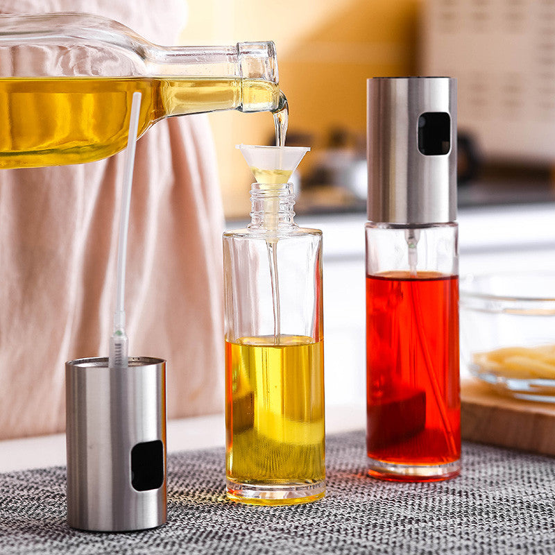 picture of a kitchen condiment bottle, oil bottle and a funnel