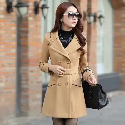 A woman wearing an Ivory colour coat, a pair of sun glasses and carrying a black bag.