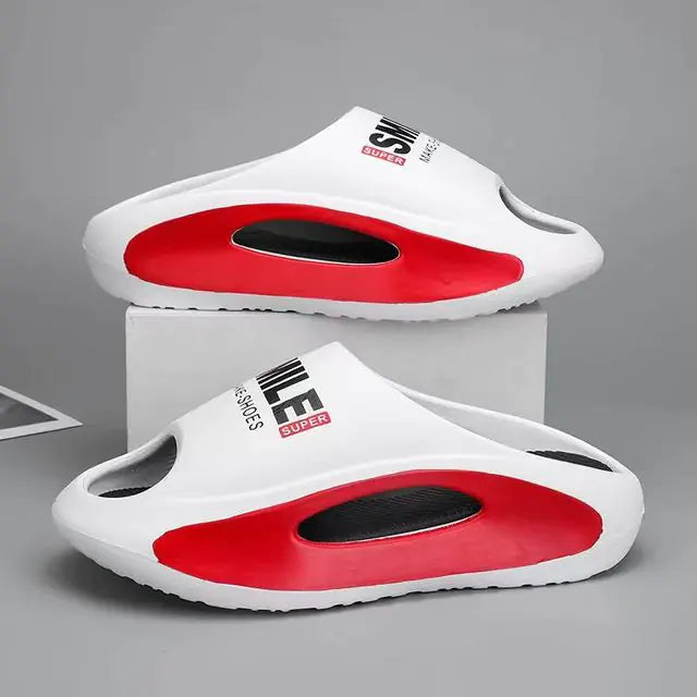 A pair of stylish black slip-on sandals with purple cushioned insoles, featuring cutout designs on the sides and toes, displayed on a white surface next to stacked books.