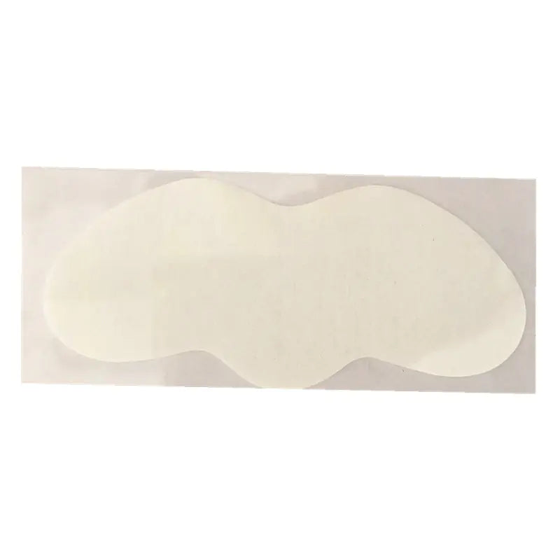 Two white adhesive patches on a beige background