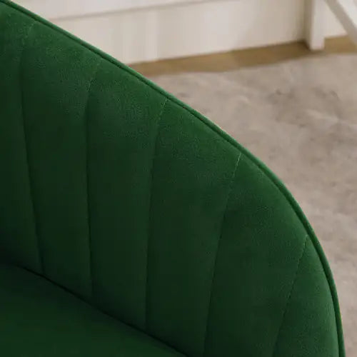 Close-up of a green upholstered chair with a blurred background
