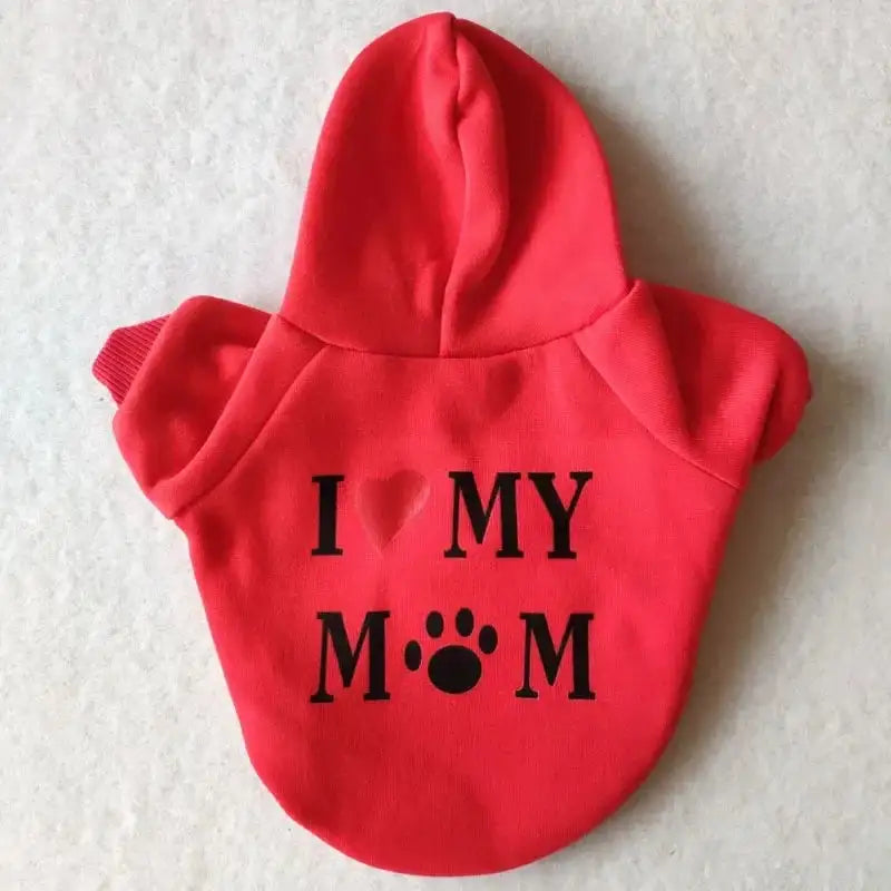 A pet hoodie with a hood and short sleeves, featuring the text 'I ❤️ MY MUM' printed on the back. The word 'Mum' includes a silhouette of a sitting dog integrated into the letter 'M'.