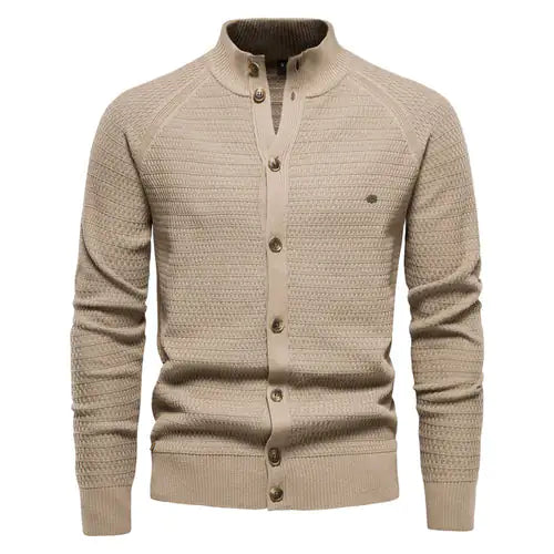 A sophisticated knitted cardigan with a mandarin collar and a button-up front. The cardigan features a textured pattern, ribbed cuffs and hem, and brown-toned buttons that add a stylish contrast. A small embroidered logo is visible on the left chest, enhancing its elegant design