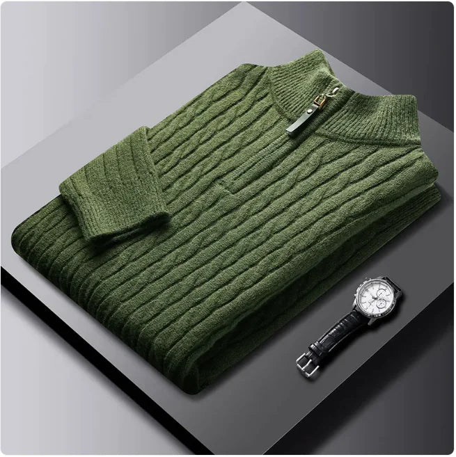 A neatly fold sweat shirt on a black surface with a black leather watch b the side