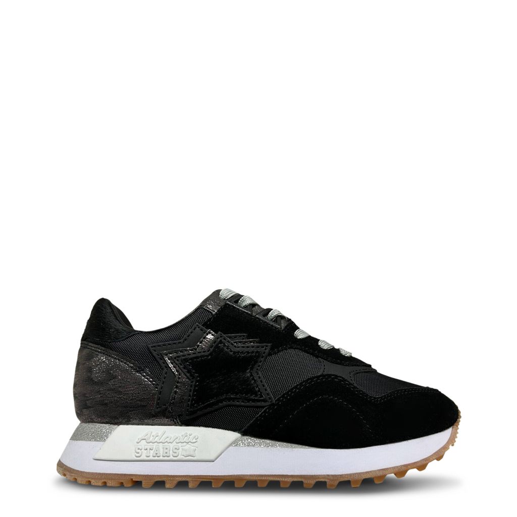 A black athletic sneaker with a white sole and gum outsole, featuring a mesh and suede upper design, viewed from the side.