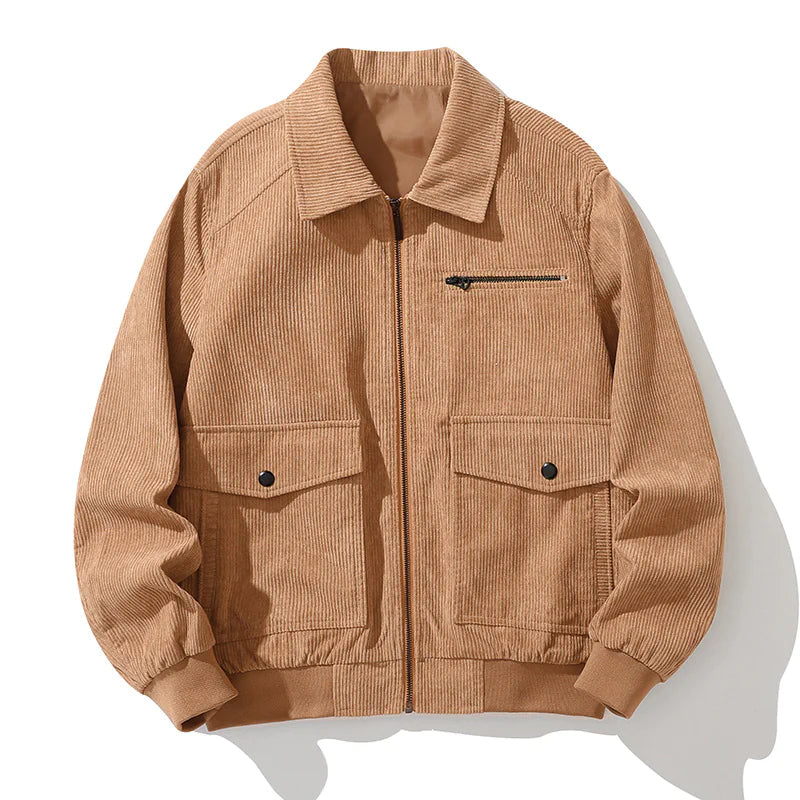 A vintage-style dark green corduroy jacket with a zip-up front, laid flat against a white background. The jacket features a classic collar, ribbed cuffs and hem, a zippered chest pocket, and two large flap pockets with button closures. The textured fabric gives it a stylish, retro-inspired look.