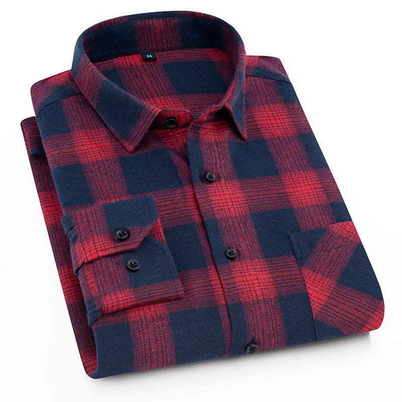 A neatly folded men's flannel shirt featuring a bold red and navy blue plaid pattern. The shirt has a classic button-down design with black buttons, a structured collar, and a single chest pocket. The soft flannel fabric gives it a warm and cozy appearance, making it ideal for casual or outdoor wear. The contrasting colors and checkered pattern add a timeless, rugged style.