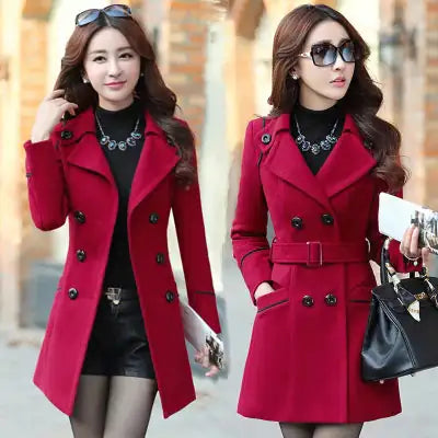 A photo of two women both wearing maroon topcoat, one carrying a black bag and a mobile phone and the other just holding a mobile phone.