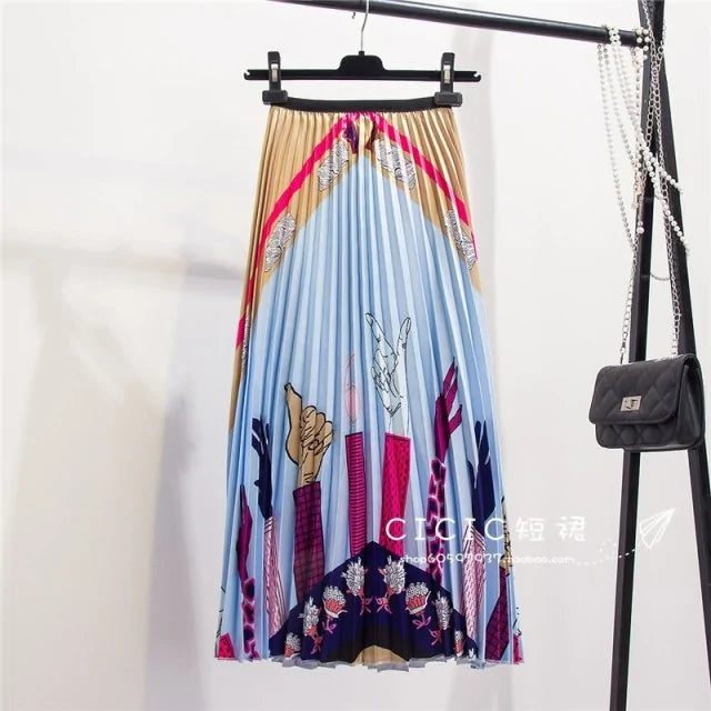 Pleated midi skirt with a gradient design, transitioning from dark black at the waistband to a soft blush pink at the hem, hanging on a black clothing rack next to a vintage-style camera.