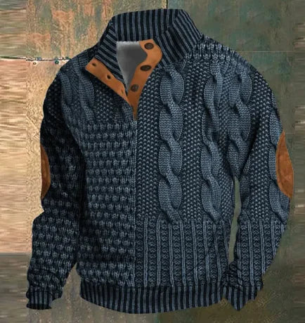 A dark brown men's pullover sweater with a textured cable knit pattern on the front. The sweater features a high ribbed collar with tan brown buttoned detailing, ribbed cuffs and hem, and matching tan elbow patches. The background consists of distressed, multicolored metal panels.