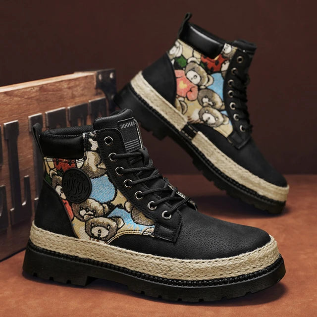 A pair of tan high-top boots with a thick jute-wrapped sole and colorful teddy bear patchwork fabric on the sides. The boots have a rugged design with metal eyelets and a branded patch on the side, displayed against a warm brown background.