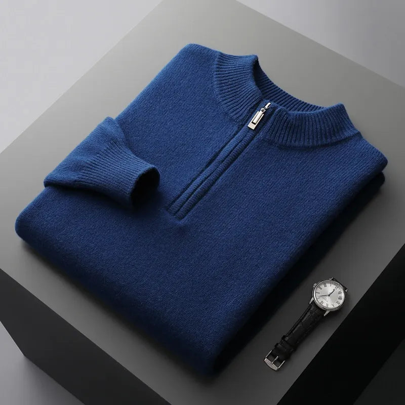 Folded sweat-shirt on a black box with a black leather watch beside it