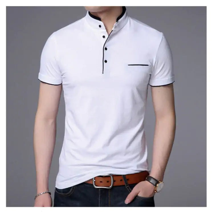 A stylish short-sleeved polo shirt with a mandarin collar, white trim detailing, and a partial button-up design. The shirt features a small decorative white-lined pocket on the left chest. The model is wearing dark jeans, a brown leather belt, a wristwatch, and a bracelet, posing casually with one hand resting on the belt buckle