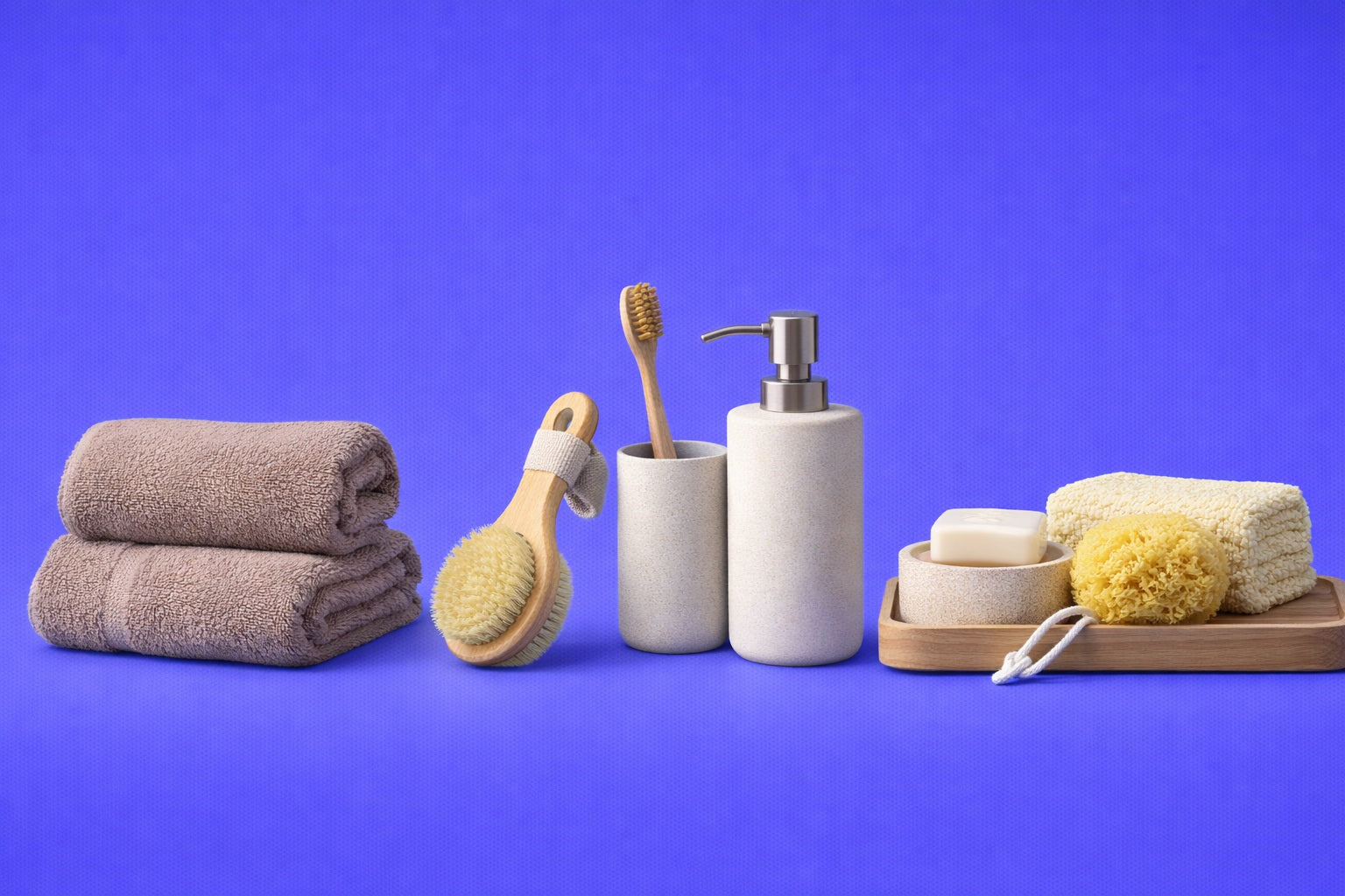 Bathroom products including towels, brushes, and soap dispenser on a blue background