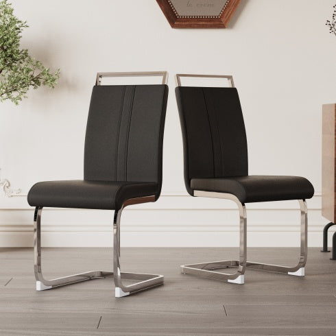 Two black chairs with metal frames on a wooden floor.