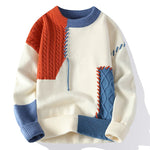 A stylish patchwork-style sweater featuring an off-white base with contrasting blue, orange, and ribbed knit textures. The design includes cable knit sections in blue and orange, decorative stitching, and ribbed cuffs, collar, and hem for a unique, modern aesthetic.