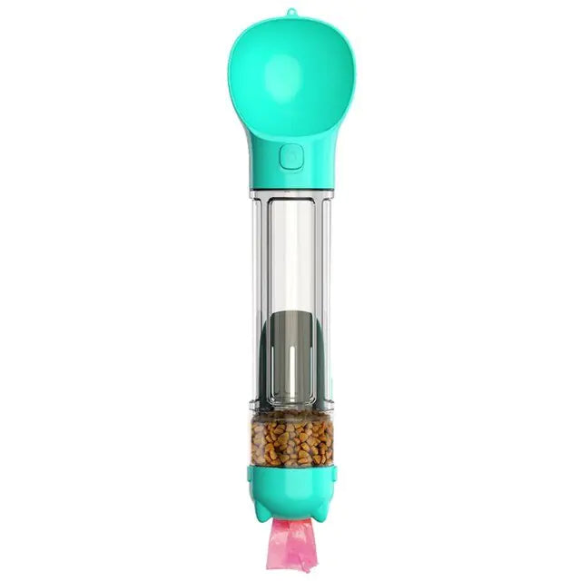 Teal handheld pet treat dispenser with a clear tube showing kibble inside and a small ribbon/strap at the bottom, on a white background.