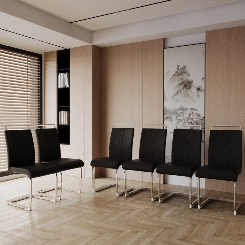 Modern office waiting room with black chairs and a painting on the wall.