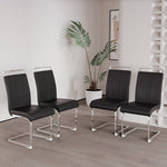 Four black chairs with clear legs in a room with a plant and wall art.