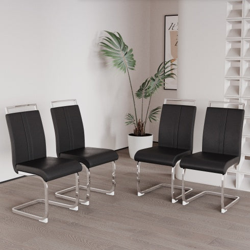 Four black chairs with clear legs in a room with a plant and wall art.