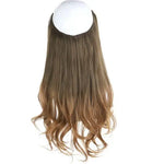 Long, wavy clip-in hair extension in medium brown with lighter ends, shown hanging on a white background.