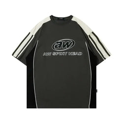 A trendy oversized T-shirt, accented by white raglan sleeves featuring stripe details. The front showcases a sporty logo-style graphic with the text "AW SPIKY HEAD" inside an oval design, adding a streetwear-inspired touch. The contrast paneling along the sides enhances its urban aesthetic, making it a great choice for casual or athleisure outfits.