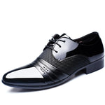 A studio product photo of a men’s black-and-white lace-up dress shoe (oxford style) on a white background, featuring a glossy black heel and sides, white toe and vamp panels, and textured black patterned sections along the midfoot with decorative stitching and strap detailing across the front.