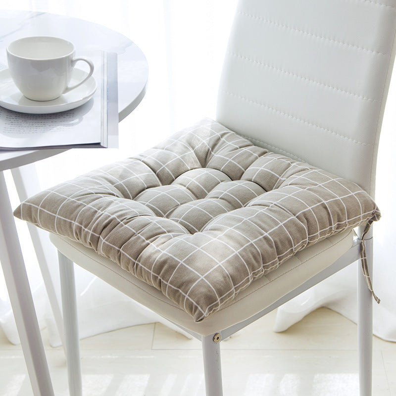Chair with a beige cushion on a white background