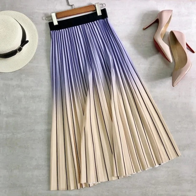 Pleated midi skirt with a gradient design, transitioning from dark black at the waistband to a soft blush pink at the hem, hanging on a black clothing rack next to a vintage-style camera.