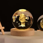 Glowing crystal ball on a wooden base, illuminated in warm light, with a 3D engraving of Santa Claus carrying a sack and surrounded by snowflakes, set against a dark background.