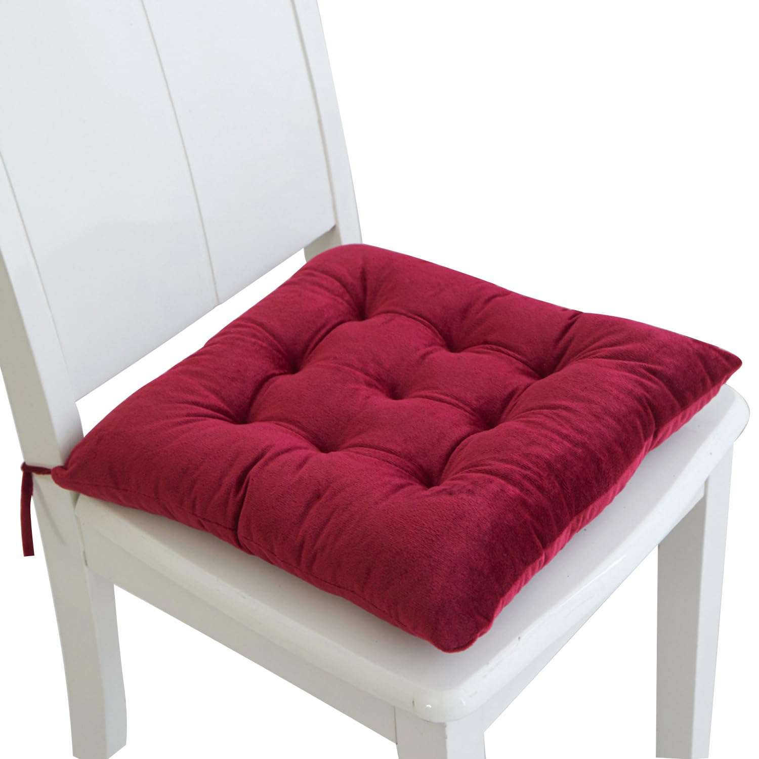 Red cushion on a white chair with a white background