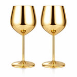 Two gold wine glasses on a white background