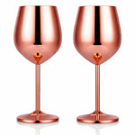 Two rose gold wine glasses on a white background