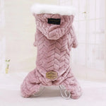 Pink plush pet hoodie jumpsuit with a braided texture design, white faux fur trim on the hood, and decorative labels on the back.