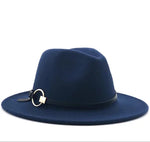 Navy blue wide-brim fedora hat with a black band and a gold ring buckle detail, shown on a white background.