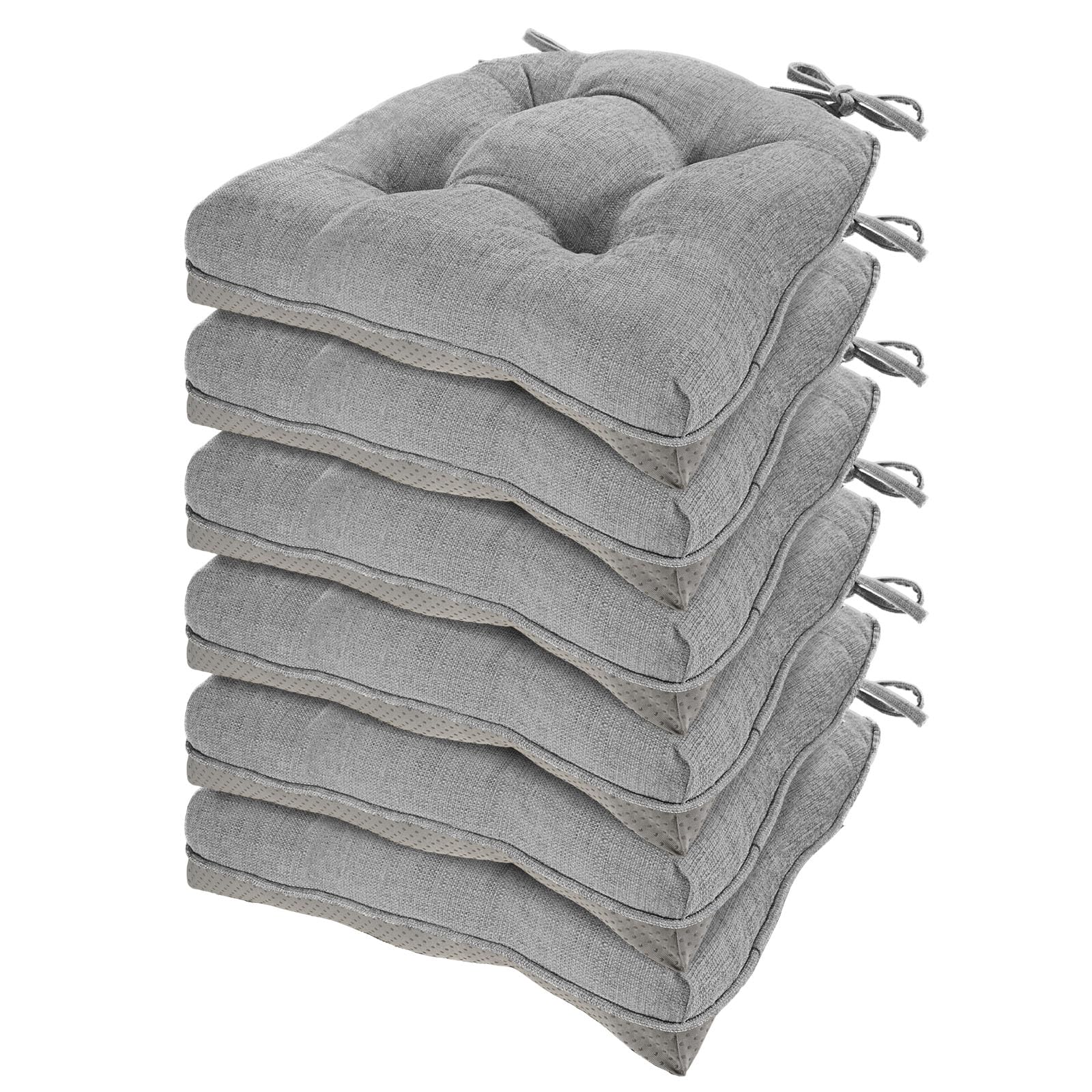 Stack of gray cushion pads with tassels on a white background
