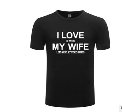 A black short-sleeve humorous t-shirt with white text that reads, "I Love It When My Wife Let’s Me Sleep In" displayed on a plain white background. Perfect for biker enthusiasts who have a playful side. Product Name: Biker T-Shirt Brand Name: STOMART ONLINE.