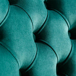 Close-up of teal fabric with a textured pattern