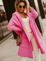 Woman wearing a bright pink coat with a blurred background