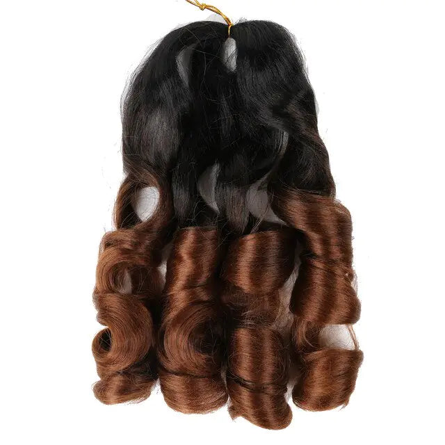 Hair extension bundle with large spiral curls, featuring black roots that fade into a warm medium-brown ombré, shown against a white background.