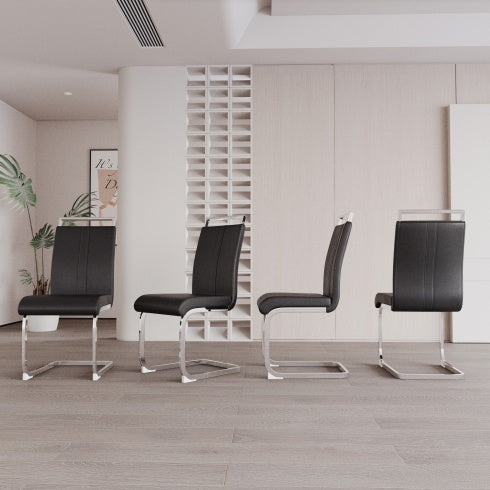 Four black chairs with metal legs arranged in a row in a modern interior setting.