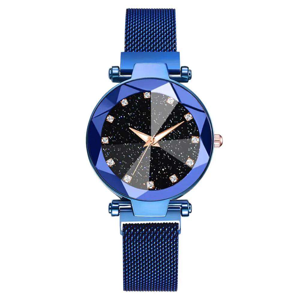 Blue mesh-band wristwatch with a faceted blue bezel, starry black dial, crystal-like hour markers, and rose-gold hands and crown.