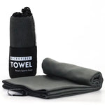Gray microfiber travel towel shown folded and rolled beside a black mesh carry bag labeled “MICROFIBER TOWEL – Beach • Sports • Travel,” on a white background.
