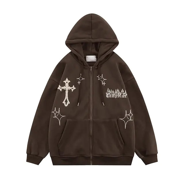 Dark brown zip-up hoodie with white graphic prints, including a cross, star-like symbols, and stylised text on the chest.
